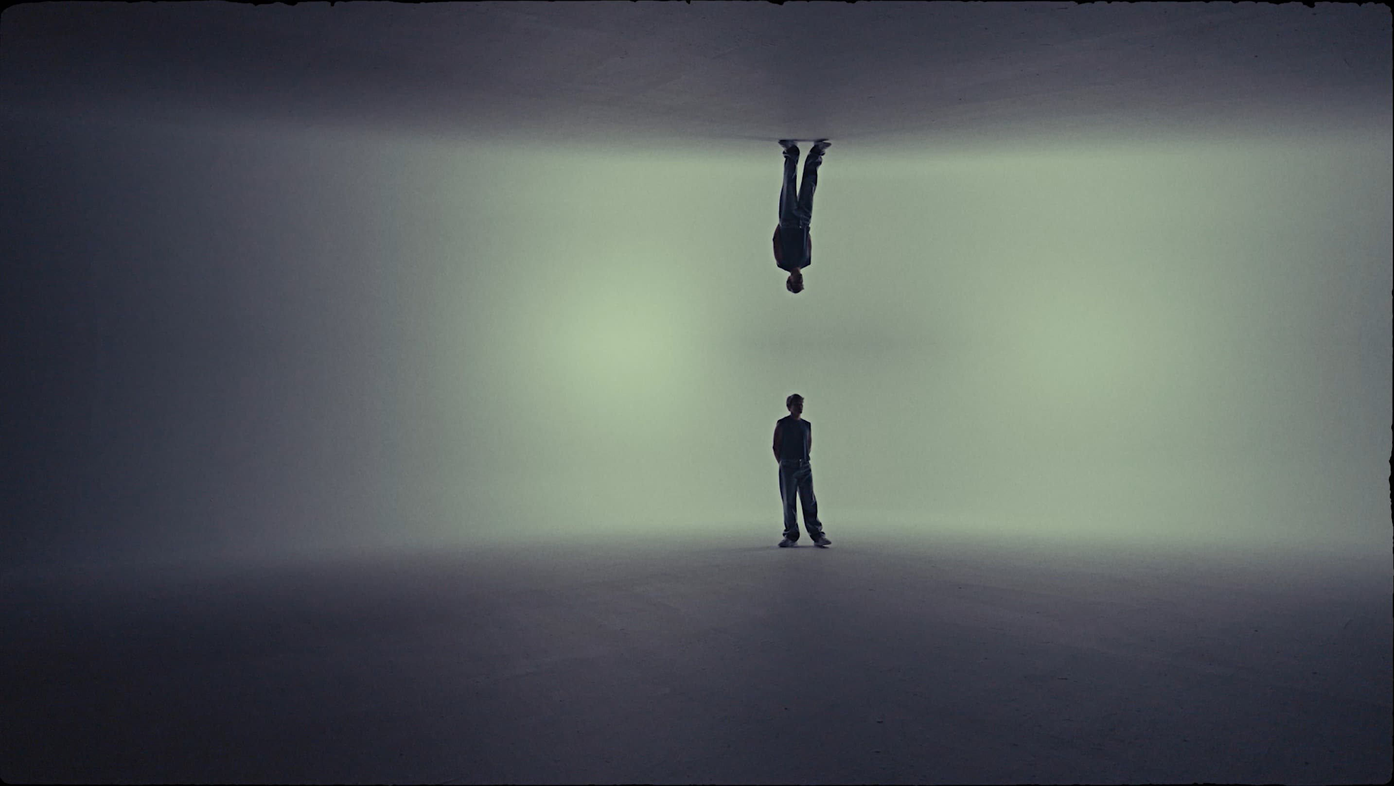 Artistic mirrored figure in teal atmosphere